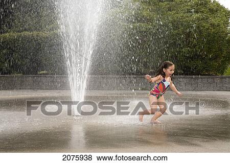 Young Asian-Caucasian Girl Running And Playing In A Water Sprinkler; Ontario Canada View Large Photo Image Stock Photo - Young Asian-Caucasian Girl Running And Playing In A Water Sprinkler; Ontario Canada. Fotosearch