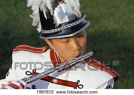 Young Asian Girl In Band Costume Playing Flute, Close-Up Headshot View Large Photo Image Stock Image - Young Asian Girl In Band Costume Playing Flute, Close-Up Headshot. Fotosearch