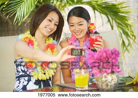 Young Asian Girls Celebrate A Great Vacation Together. View Large Photo Image Stock Photography - Young Asian Girls Celebrate A Great Vacation Together.. Fotosearch