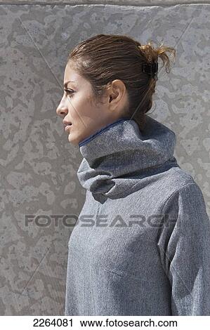 Stock Image - Young Attractive Iranian Woman Wearing Stylish Clothing Against A Concrete Wall; Winnipeg Manitoba Canada. Fotosearch