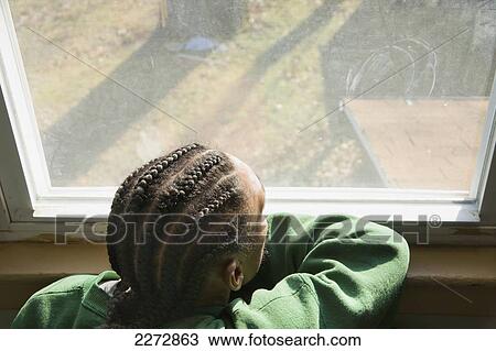 Young black man looking out his bedroom window; hartford connecticut usa View Large Photo Image Stock Image - Young black man looking out his bedroom window; hartford connecticut usa. Fotosearch