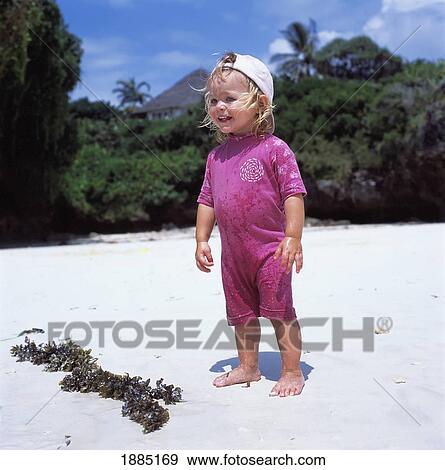 Young Blond Child Standing On Beach By Seaweed View Large Photo Image Stock Photo - Young Blond Child Standing On Beach By Seaweed. Fotosearch