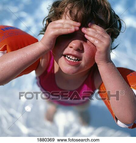 Stock Photo - Young Blonde Girl In Swimming Armbands In A Pool. Fotosearch