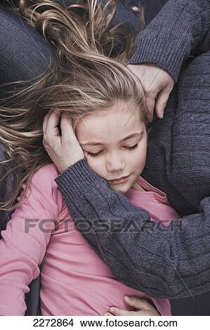Young blonde girl lying in her mother's lap; hartford connecticut usa View Large Photo Image Picture - Young blonde girl lying in her mother's lap; hartford connecticut usa. Fotosearch