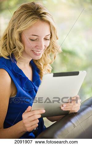 Young Blonde Woman Using A Tablet; Bradford Ontario Canada View Large Photo Image Stock Photo - Young Blonde Woman Using A Tablet; Bradford Ontario Canada. Fotosearch
