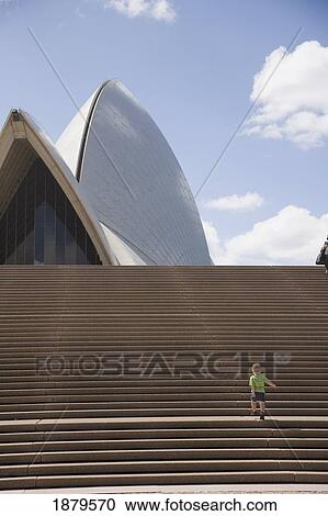 Stock Image - Young Boy Ascending Stairs Outside Sydney Opera House. Fotosearch