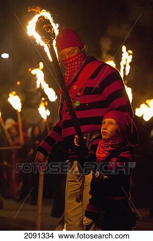 Picture - Young Boy Dressed As A Smuggler With Burning Torch On The United Grand Procession, Bonfire Night, Lewes, East Sussex, Uk. Fotosearch