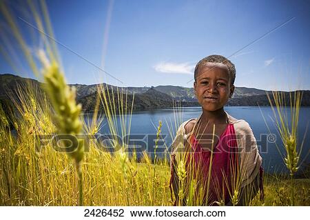 Stock Image - Young boy in wheat field, Wenchi crater and lake, to the West of Addis Ababa; Ethiopia. Fotosearch