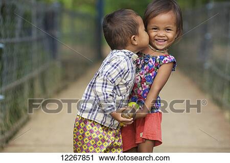 Young boy kissing a young girl; Battambang, Cambodia View Large Photo Image Stock Image - Young boy kissing a young girl; Battambang, Cambodia. Fotosearch