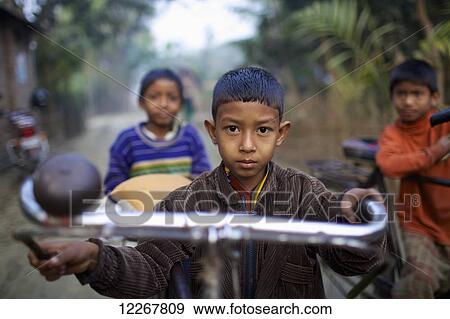 Young boy on a bicycle; Rangpur, Bangladesh View Large Photo Image Stock Photo - Young boy on a bicycle; Rangpur, Bangladesh. Fotosearch