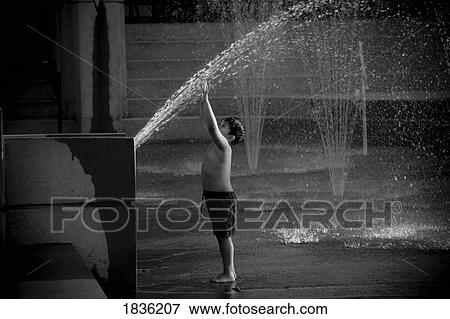 Young Boy Playing In Fountain Spray View Large Photo Image Stock Photo - Young Boy Playing In Fountain Spray. Fotosearch
