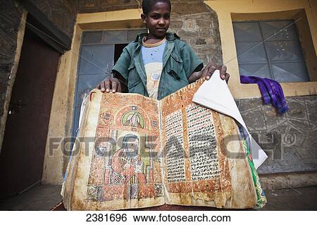 Young boy showing an ancient bible at a church; Ethiopia View Large Photo Image Stock Photograph - Young boy showing an ancient bible at a church; Ethiopia. Fotosearch