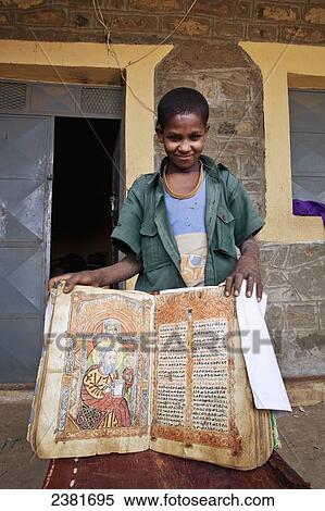 Young boy showing an ancient bible at a church; Ethiopia View Large Photo Image Stock Photography - Young boy showing an ancient bible at a church; Ethiopia. Fotosearch