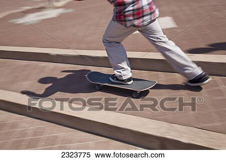 Young boy skateboarding View Large Photo Image Stock Photography - Young boy skateboarding. Fotosearch
