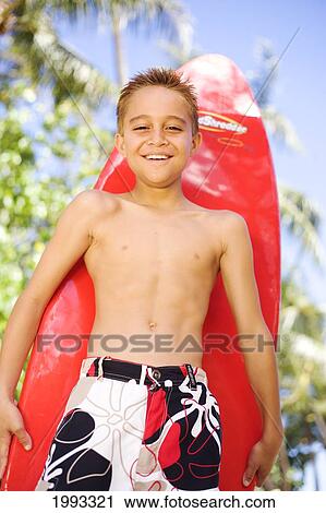 Young Boy Smiling With Bright Red Surfboard View Large Photo Image Stock Image - Young Boy Smiling With Bright Red Surfboard. Fotosearch