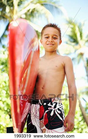Stock Photo - Young Boy Smiling With Bright Red Surfboard. Fotosearch