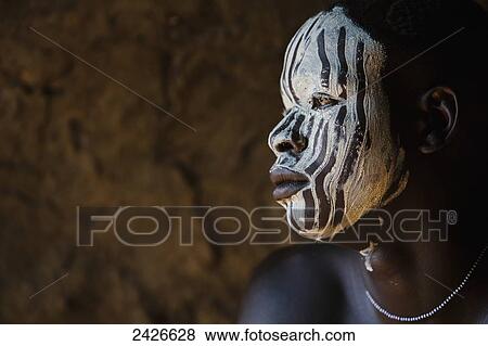 Stock Photo - Young boy with traditional painted face, paint made from natural ground river stones, Omo region, Southwest Ethiopia; Kibish, Ethiopia. Fotosearch