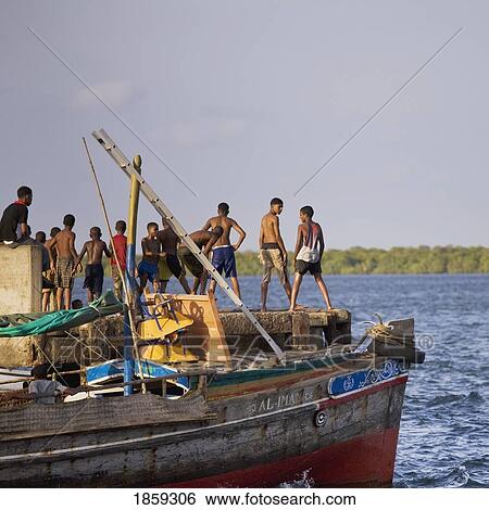 Young Boys Jumping Into The Sea By The Jetty At Lamu, Kenya, East Africa View Large Photo Image Stock Photograph - Young Boys Jumping Into The Sea By The Jetty At Lamu, Kenya, East Africa. Fotosearch
