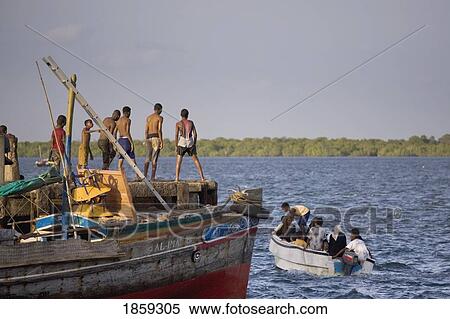 Stock Photography - Young Boys Jumping Into The Sea By The Jetty At Lamu, Kenya, East Africa. Fotosearch