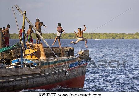 Young Boys Jumping Into The Sea Off Jetty; Lamu, Kenya View Large Photo Image Stock Photo - Young Boys Jumping Into The Sea Off Jetty; Lamu, Kenya. Fotosearch