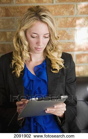 Stock Image - Young Businesswoman Using A Tablet; Bradford Ontario Canada. Fotosearch