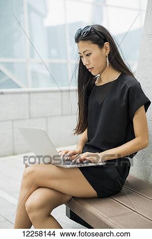 Young businesswoman working on her laptop computer; Xiamen, China View Large Photo Image Picture - Young businesswoman working on her laptop computer; Xiamen, China. Fotosearch
