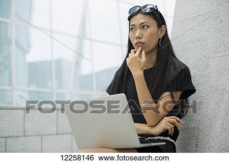 Young businesswoman working on her laptop computer; Xiamen, China View Large Photo Image Stock Photograph - Young businesswoman working on her laptop computer; Xiamen, China. Fotosearch
