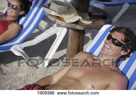 Stock Photograph - Young Couple Sunbathing On Beach, Mayan Riviera, Yucatan Peninsular, Quintana Roo State, Mexico. Fotosearch
