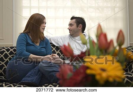 Young Couple Talking In A Living Room, Whitby, Ontario View Large Photo Image Stock Image - Young Couple Talking In A Living Room, Whitby, Ontario. Fotosearch