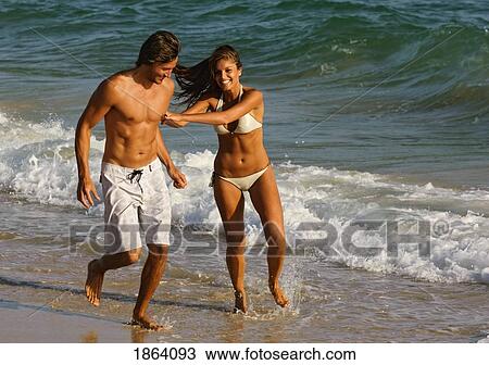 Young Couple Walking On Beach View Large Photo Image Stock Image - Young Couple Walking On Beach. Fotosearch