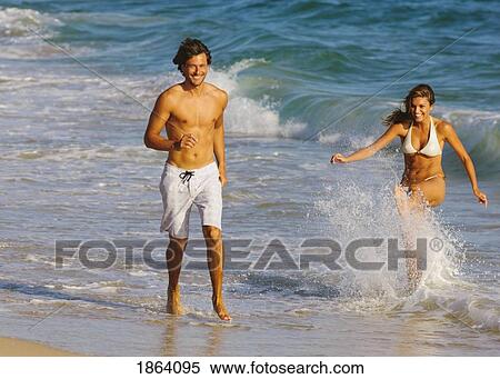 Young Couple Walking On Beach View Large Photo Image Stock Photography - Young Couple Walking On Beach. Fotosearch