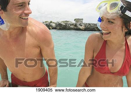 Stock Photography - Young Couple Wearing Snorkeling Gear In Sea On Mayan Riviera, Yucatan Peninsular, Quintana Roo State, Mexico. Fotosearch