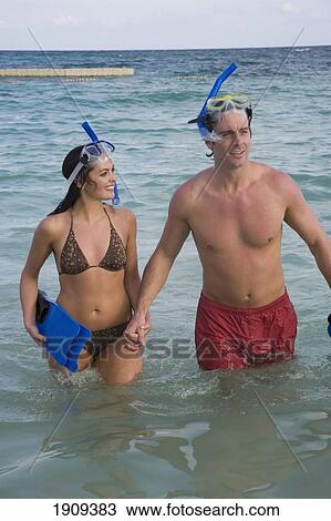 Stock Image - Young Couple With Snorkeling Gear In Sea On Mayan Riviera, Yucatan Peninsular, Quintana Roo State, Mexico. Fotosearch