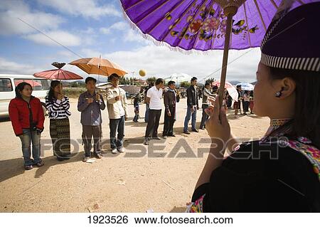 Young Couples Court Each Other Whilst Throwing Tennis Balls Back And Forth At The Hmong New Year Festival, Phonsavan, Laos View Large Photo Image Stock Photograph - Young Couples Court Each Other Whilst Throwing Tennis Balls Back And Forth At The Hmong New Year Festival, Phonsavan, Laos. Fotosearch