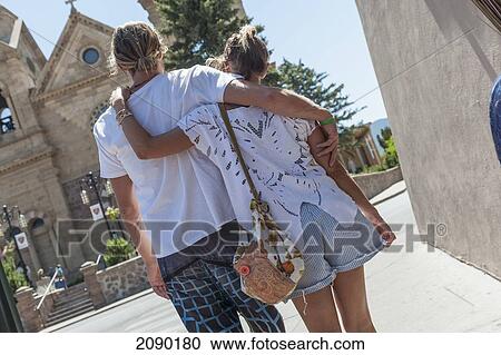 Young Fashionable Couple Walking Arm In Arm By The St Francis Cathedral, Santa Fe, New Mexico, Usa View Large Photo Image Stock Image - Young Fashionable Couple Walking Arm In Arm By The St Francis Cathedral, Santa Fe, New Mexico, Usa. Fotosearch