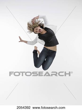 Young Female Jumping Up In The Air On A White Background View Large Photo Image Stock Image - Young Female Jumping Up In The Air On A White Background. Fotosearch