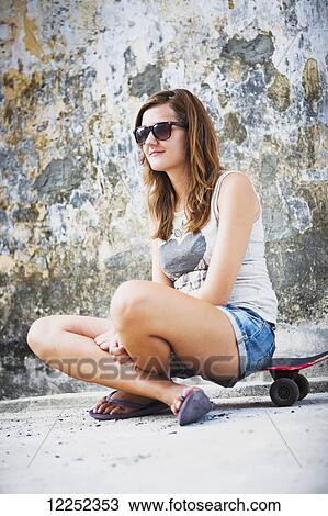 Young female tourist with a skateboard on a downtown street; Penang, Malaysia View Large Photo Image Stock Image - Young female tourist with a skateboard on a downtown street; Penang, Malaysia. Fotosearch
