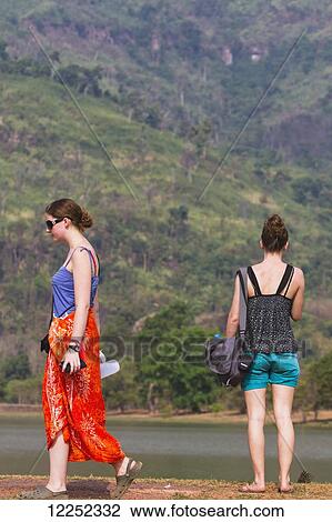 Stock Image - Young female tourists visiting Wat Phu temple; Wat Phu, Laos. Fotosearch