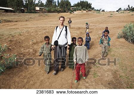 Young female trekker walking with local children in the Simien mountains; Ethiopia View Large Photo Image Stock Image - Young female trekker walking with local children in the Simien mountains; Ethiopia. Fotosearch