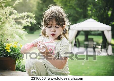 Young Girl Blowing Bubbles Outside In Her Pyjamas On A Summer Morning; Maricourt Quebec Canada View Large Photo Image Stock Photograph - Young Girl Blowing Bubbles Outside In Her Pyjamas On A Summer Morning; Maricourt Quebec Canada. Fotosearch