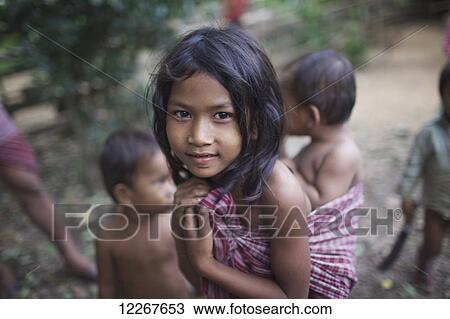 Young girl carries her brother in a krawma; Mondulkiri, Cambodia View Large Photo Image Stock Image - Young girl carries her brother in a krawma; Mondulkiri, Cambodia. Fotosearch