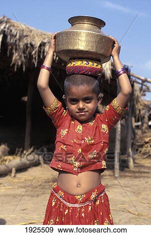 Stock Photo - Young Girl Carrying Pot Of Water, Portrait; Gujarat State, India. Fotosearch