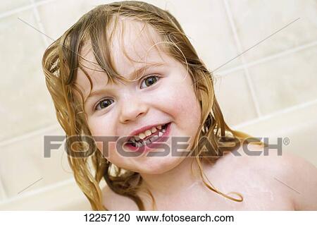 Stock Image - Young girl having a fun bath; Millet, Alberta, Canada. Fotosearch