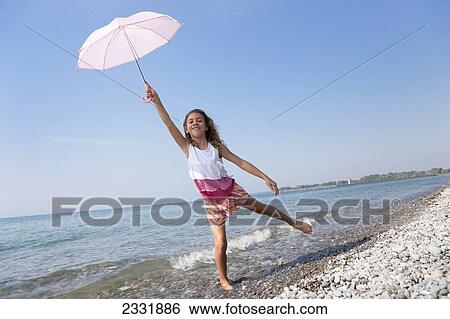 Young Girl Holding Her Pink Parasol Over Her Head On The Shore Of Lake Ontario; Whitby Ontario Canada View Large Photo Image Stock Photograph - Young Girl Holding Her Pink Parasol Over Her Head On The Shore Of Lake Ontario; Whitby Ontario Canada. Fotosearch