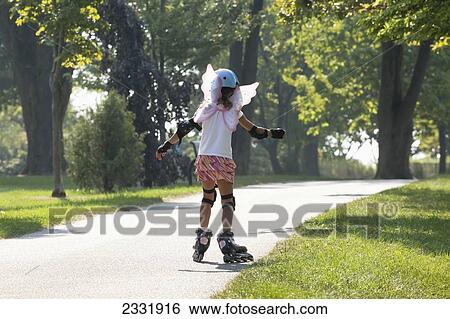 Young Girl Learning To Inline Skate While Wearing Fairy Wings; Whitby Ontario Canada View Large Photo Image Stock Photograph - Young Girl Learning To Inline Skate While Wearing Fairy Wings; Whitby Ontario Canada. Fotosearch