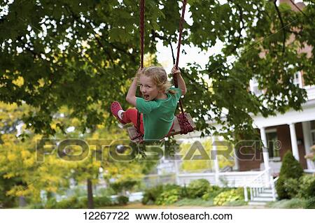 Young girl on a swing; Picton, Ontario, Canada View Large Photo Image Stock Image - Young girl on a swing; Picton, Ontario, Canada. Fotosearch