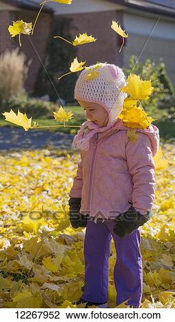 Young girl playing in the leaves in autumn; Guelph, Ontario, Canada View Large Photo Image Stock Image - Young girl playing in the leaves in autumn; Guelph, Ontario, Canada. Fotosearch