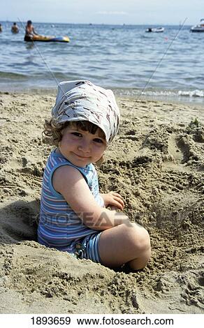 Stock Photo - Young Girl Playing On Beach In Sands. Fotosearch