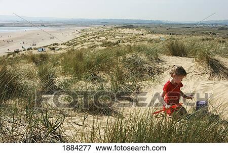 Young Girl Playing On Sand Dune With Bucket And Spade View Large Photo Image Stock Photo - Young Girl Playing On Sand Dune With Bucket And Spade. Fotosearch
