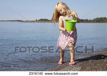 Young Girl Playing On The Beach By Lake Ontario; Ontario Canada View Large Photo Image Stock Image - Young Girl Playing On The Beach By Lake Ontario; Ontario Canada. Fotosearch